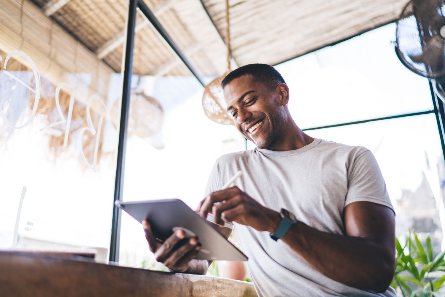 Sean smiling while he works on a tablet