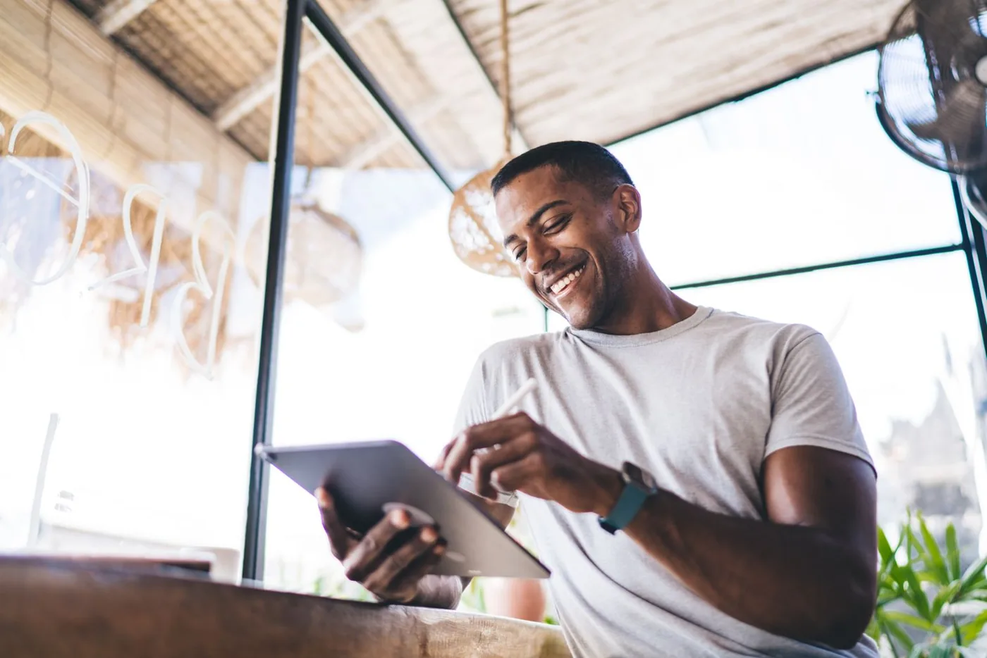 Sean smiling while he works on a tablet